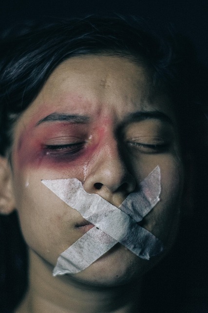 woman with taped mouth, crying